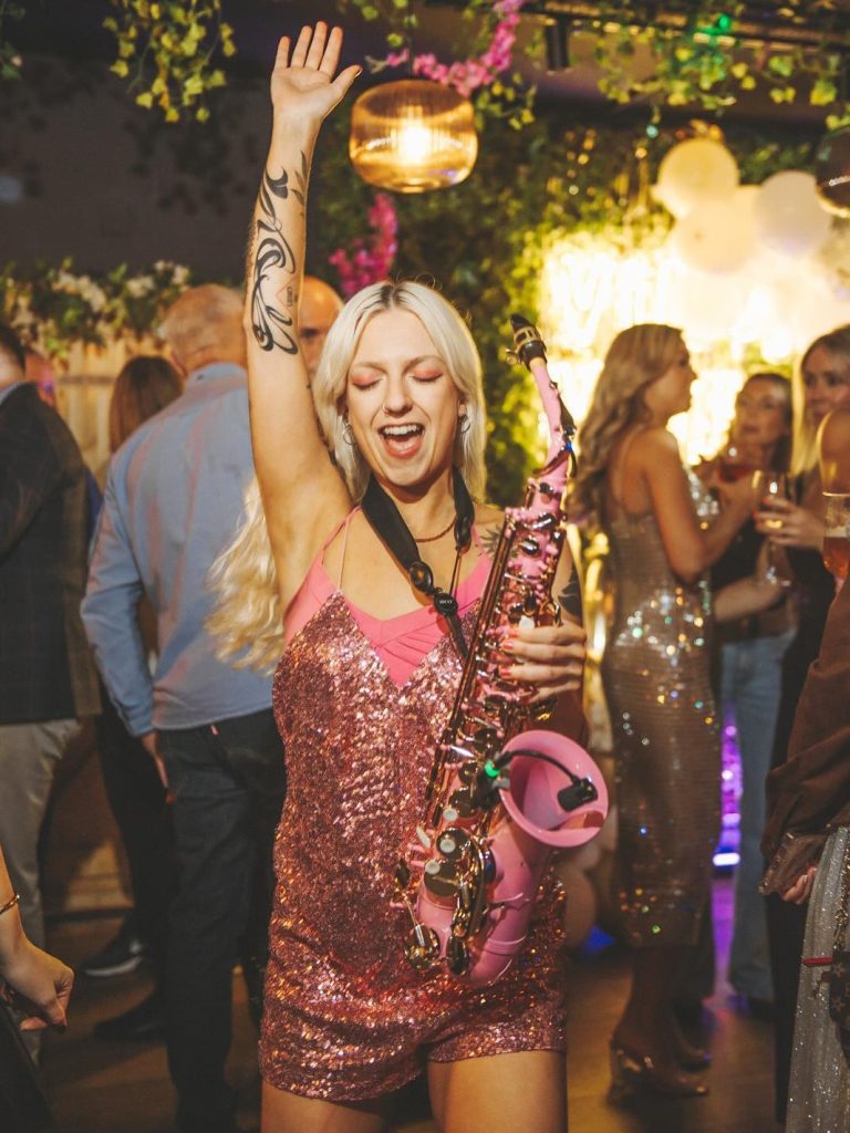 Jem On Sax with pink saxophone performing at a destination wedding in France